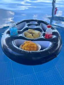 an inflatable raft with food and drinks in the water at JLB Resort and Tours,Mango Rooms in Valdez