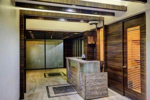 a room with a lobby with a large glass door at Hotel Lonavla in Lonavala