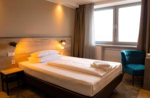 Postel nebo postele na pokoji v ubytování Hotel Sportforum