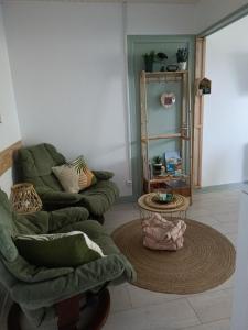 a living room with a couch and a table at appartement cosy parking privé in Chazey-sur-Ain