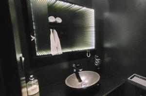 a bathroom with a sink and a mirror at Suite Chic - Antre-parenthèse in Gravelines