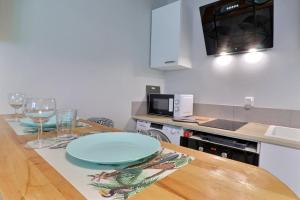 a kitchen with a table with a plate on it at Les Apparts du Pont Vert - lit double - WiFi - tout inclus - 5 in Troyes +4 photos