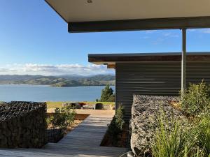 a house with a deck with a view of a lake at Kūkupa Pavilion in Oue