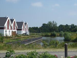 a row of houses next to a river at Villa Seeblick - Nordhorn in Nordhorn