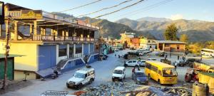 a town with cars parked in a parking lot at Hotel Grand View in Barkot