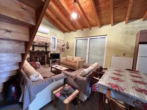 a living room with a couch and a table at AgroPhilia in Kourkouloí