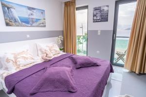 a bedroom with a purple bed with a teddy bear on it at Apartments Toni in Baška
