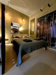 a bedroom with two beds and a large window at Slapen aan de Sluis in Utrecht