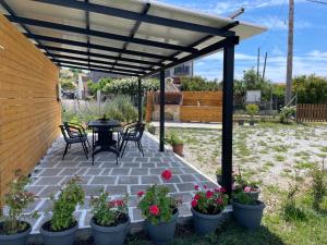 a patio with a table and chairs under a pergola at VICTORY SUITES in Samothraki