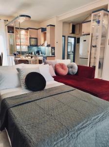 a bedroom with a large bed with pillows on it at Theros Seaside House - Volos in Marathos
