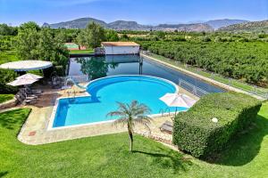a swimming pool in the middle of a yard at Orange Grove Villa in Nafplio