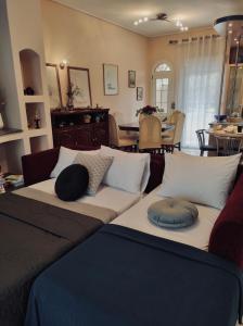 a couch with pillows on it in a living room at Theros Seaside House - Volos in Marathos