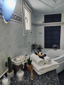 a couple laying in a bath tub in a bathroom at Theros Seaside House - Volos in Marathos +33 photos