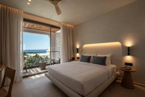 Cama ou camas em um quarto em Nuca Mykonos