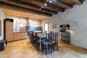 a kitchen with a table and chairs in a room at Maison De Vacances Chêne in Auriac-du-Périgord