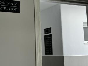 a door with a sign on the side of a building at Hotel Puerta del Mar - Adults Recommended in Nerja