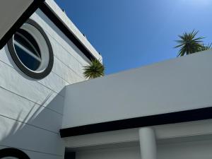 a white building with plants on the side of it at Hotel Puerta del Mar - Adults Recommended in Nerja