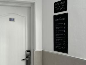 a sign on a wall next to a bathroom door at Hotel Puerta del Mar - Adults Recommended in Nerja
