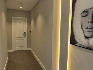 a hallway with a picture of a woman on the wall at Hotel Puerta del Mar - Adults Recommended in Nerja