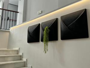 a wall with a plant hanging on a wall at Hotel Puerta del Mar - Adults Recommended in Nerja