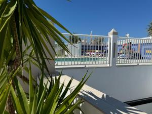 a balcony with a white railing and a pool at Hotel Puerta del Mar - Adults Recommended in Nerja
