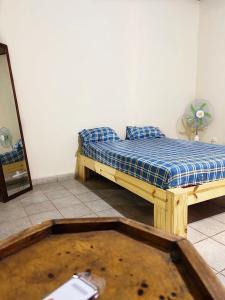 a bedroom with a bed in a room with a mirror at Serene Room and Living Room in Serekunda