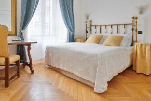 a bedroom with a bed and a chair and a desk at Charles Bridge Palace in Prague