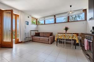 a living room with a couch and a table at Appartamento SOLE in Brenzone sul Garda