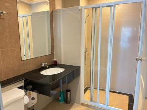 a bathroom with a sink and a glass shower at Luxury Villa Patong in Patong Beach +4 photos