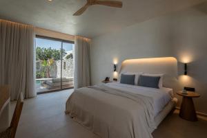 Cama ou camas em um quarto em Nuca Mykonos