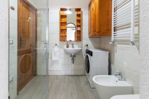 a bathroom with a sink and a toilet and a shower at Villa fantastica Villasimius in Capitana +54 photos