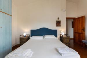 a bedroom with a large bed with two night stands at Villa fantastica Villasimius in Capitana