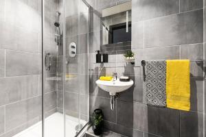 a bathroom with a sink and a shower at Yugo Explore New Mill in Dublin