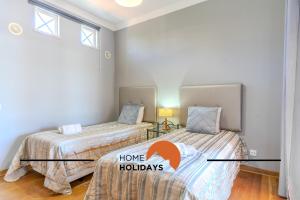 a bedroom with two beds and a window at #307 Vila Branca by Home Holidays in Albufeira