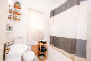 a bathroom with a sink and a toilet and a shower at Corfu Blue Memories Apartment 1 in Corfu Town