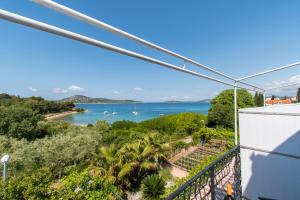 a view of the ocean from the balcony of a house at Apartments Njoko in Prvić Šepurine