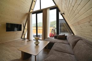 a living room with a couch and a table at Avra Resort Tsaghkadzor in Tsaghkadzor