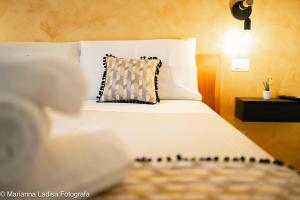 a bedroom with a white bed with a pillow at Dimora Capruzzi 37 in Bari