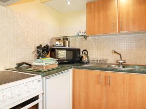 a kitchen with a sink and a microwave at Barn Cottage in Liskeard