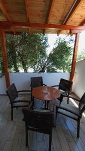 a wooden table and chairs on a patio at House Eugenia Sarti in Sarti +32 photos