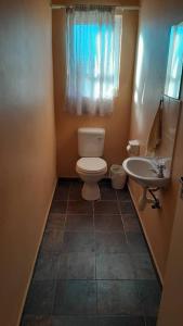 a small bathroom with a toilet and a sink at The 2nd Seagull in Swakopmund