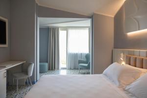 Postel nebo postele na pokoji v ubytování Grand Hotel