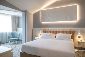 Postel nebo postele na pokoji v ubytování Grand Hotel
