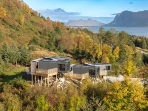 two modular homes on a hill with a view of the water at Torvika Seaview Pods in Bølandet