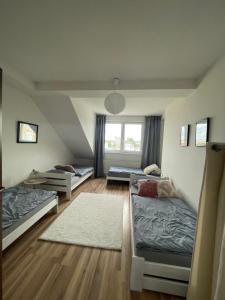 a room with two beds and a window at 7 people - 1 price - Cozy attic apartment in Prešov