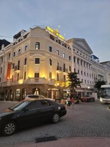 a black car parked in front of a building at VĨNH KHANG HẠ LONG HOTEL in Ha Long +59 photos