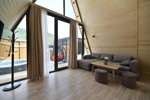 a living room with a couch and a table at Avra Resort Tsaghkadzor in Tsaghkadzor