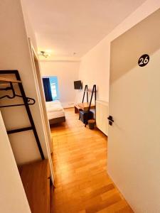 a room with a bedroom with a bed and a ladder at Hotel Zum Pfalzgrafen in Heidelberg