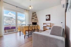 a living room with a couch and a table with a view at Casa Edda in Brenzone sul Garda