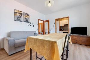a living room with a table and a couch at Casa Edda in Brenzone sul Garda